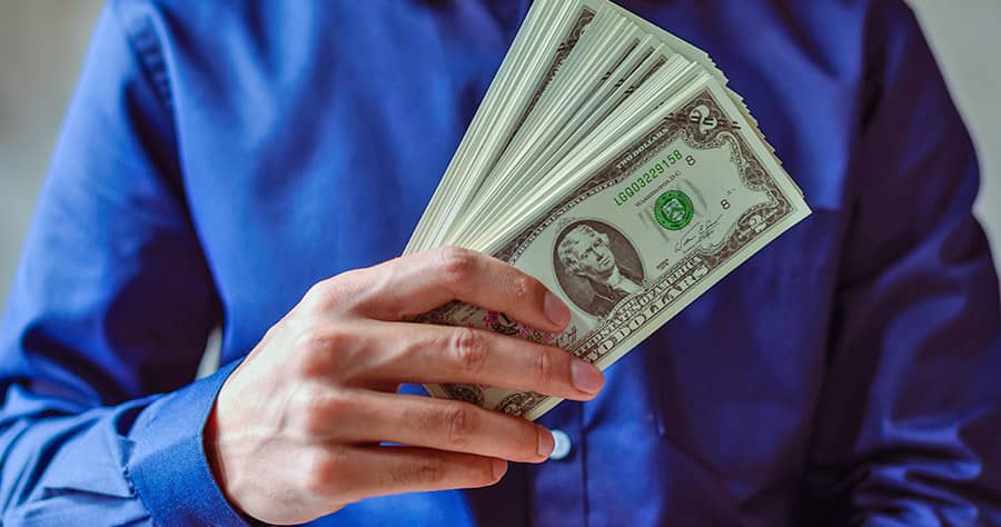 BLN Person Holding Money Business Loans Network